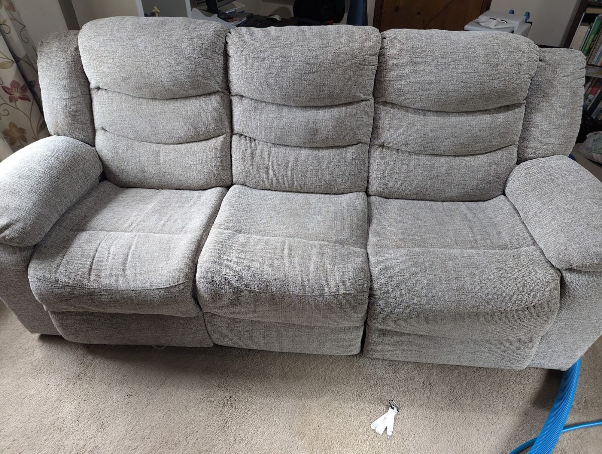 Three-seater fabric sofa freshly cleaned
